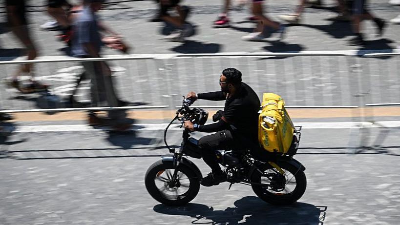 Heatwave Drives Delivery Riders in Italy to Strike, Demanding Safety and Fair Wages