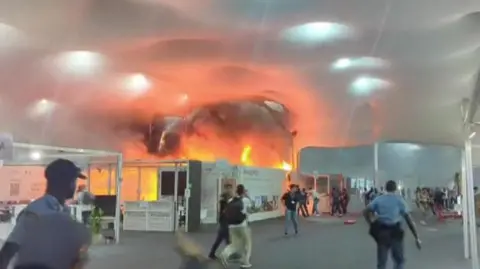 Chaos Erupts at COP30 as Fire Forces Evacuation